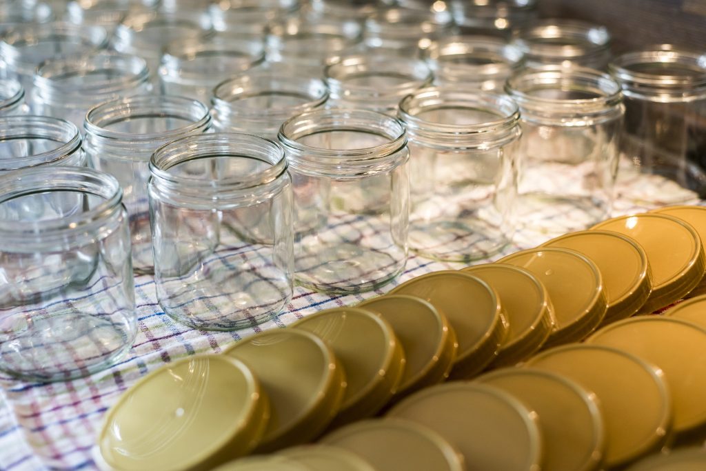 many glass jar empty glasses row for jam or honey with lid caps abstract background bokeh